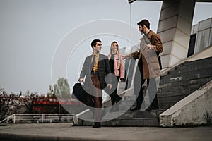 Professional colleagues walking and talking in an outdoor urban setting