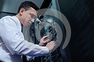 Professional computer engineer looking at the data server