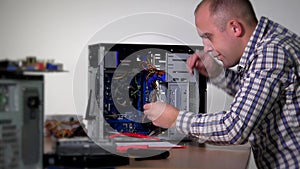 Professional computer service specialist man remove and examine ram memory