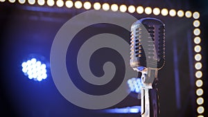 Professional concert vintage glare microphone. Mic for record or speak to audience on stage in empty retro club close up