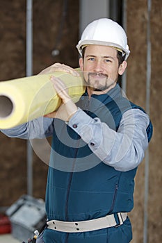 Professional construction engineer holding paper roll