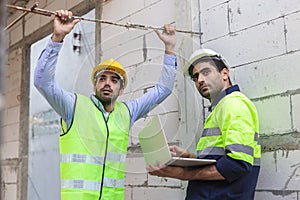 Professional construction engineer team, Two man engineer wear uniform holding laptop looking at camera standing at construction