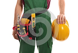 Professional construction worker with hard hat and tool belt on white background