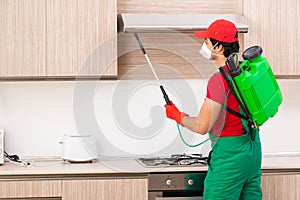 The professional contractor doing pest control at kitchen