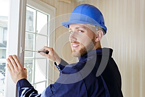 professional contractor using screwdriver on window