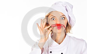 Professional cook in chef hat and uniform with mustache from red hot chili pepper. Spicy food concept. Chili pepper for