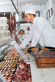 Professional cook sniffing freshly cooked dish