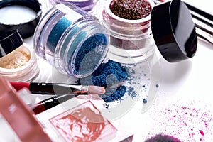 Professional cosmetics and brushes for make-up on a white background.