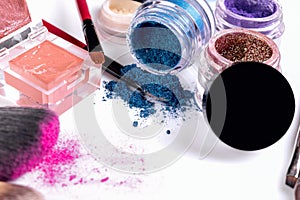Professional cosmetics and brushes for make-up on a white background.