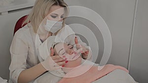 A professional cosmetologist does a face massage procedure before applying a mask. New concept in cosmetology.