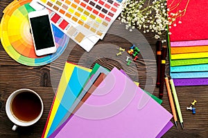 Professional creative graphic designer desk on wooden background top view