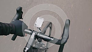 Professional cyclist pedaling on road bike, close up top view. Road bicycle handlebar. Male hand is holding bike handlebar. Top vi