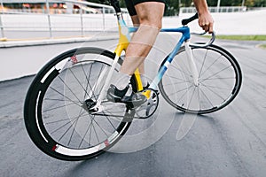 A professional cyclist rides on a beautiful and vibrant city bike. Man on a fixed bike.