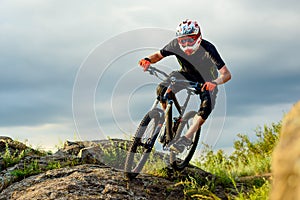 Professional Cyclist Riding the Bike on the Rocky Trail. Extreme Sport.