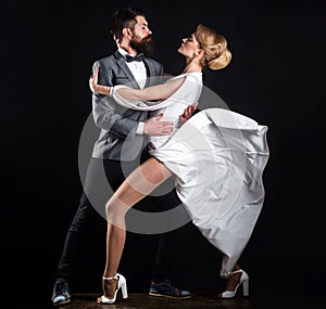 Professional dancers in ballroom. Sensual couple in love dancing tango with passion.