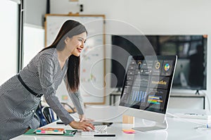 Professional data analyst using data visualizations dashboard on computer monitor for data business analysis and Data