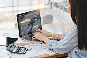Professional data analyst using data visualizations dashboard on computer monitor for data business analysis and Data