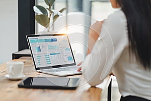 Professional data analyst using data visualizations dashboard on computer monitor for data business analysis and Data