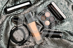 Professional decorative cosmetics, makeup tools and accessory on shiny silver background with copy space for text