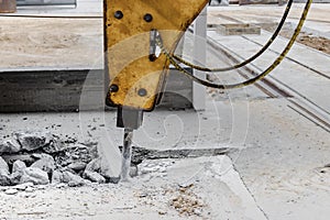 Professional demolition of reinforced concrete structures with an industrial hydraulic hammer with an excavator. Dismantling the