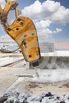 Professional demolition of reinforced concrete structures with an industrial hydraulic hammer with an excavator. Dismantling the