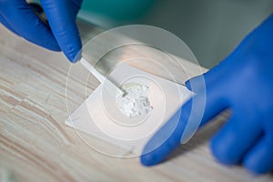 Professional dentist mixing filling material at the stomatology clinic