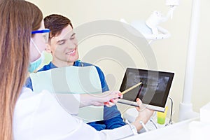 Professional dentist with patient in hospital