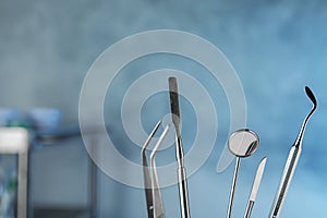 Professional dentist tools on blurred background