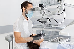 Professional dentist using modern technologies in treatment