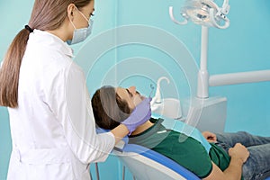 Professional dentist working with patient