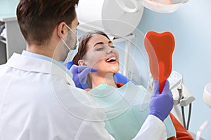 Professional dentist working with patient