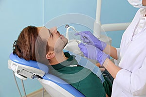 Professional dentist working with patient