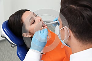 Professional dentist working with patient