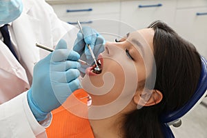 Professional dentist working with patient