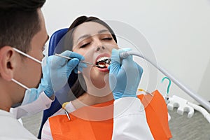 Professional dentist working with patient