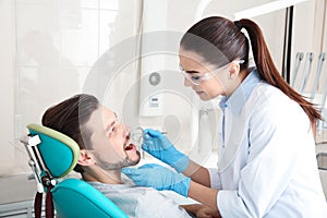 Professional dentist working with patient in clinic