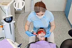 Professional dentist working with patient in modern clinic