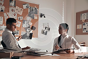 Professional detectives working at desk in office