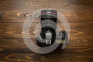 Professional digital camera on wooden background