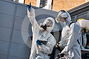 Professional disinfectors looking for potentially dangerous places