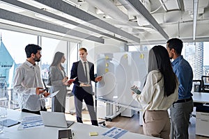 Professional diverse business team at presentation in office meeting room.