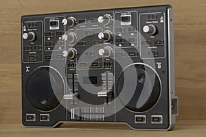Professional DJ Controller with Dual Jog Wheels, Mixers and Effect Controls on Wooden Surface