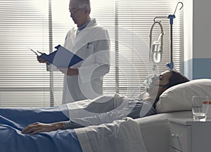 Professional doctor assisting a patient and checking medical records