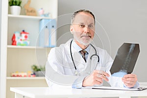 Professional doctor holding radiogram