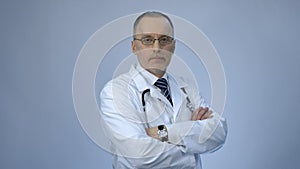 Professional doctor looking at camera, high quality medical services at hospital