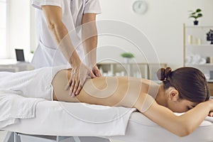 Professional doctor masseur during work with patient in medical clinic