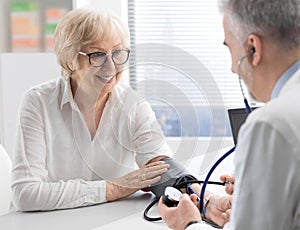 Professional doctor measuring a patient`s blood pressure