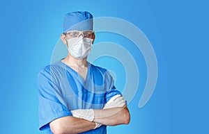 Professional doctor in medical mask isolated on a blue background. Health Care Concept. Hospital staff