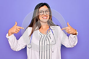 Professional doctor woman wearing stethoscope and medical coat over purple background looking confident with smile on face,