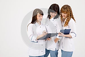 Professional doctor working in hospital office with nurses. Medical technology research institute and doctor staff service concept